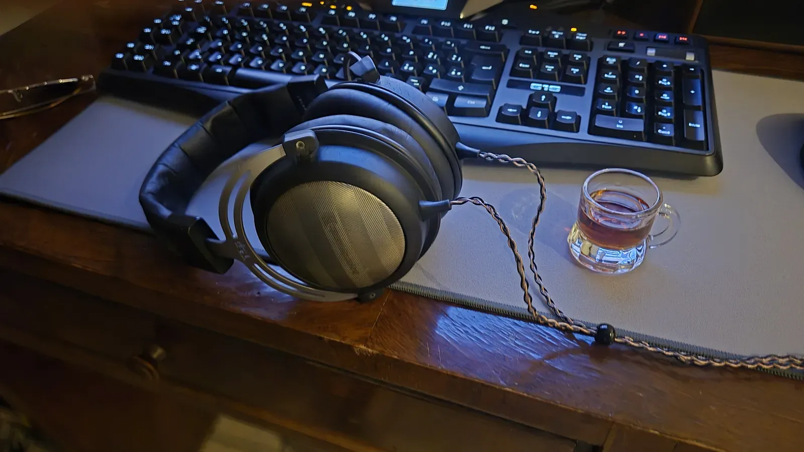 Le Beyerdynamic T5p rimontate sulla scrivania davanti alla tastiera, con il cavo intrecciato collegato